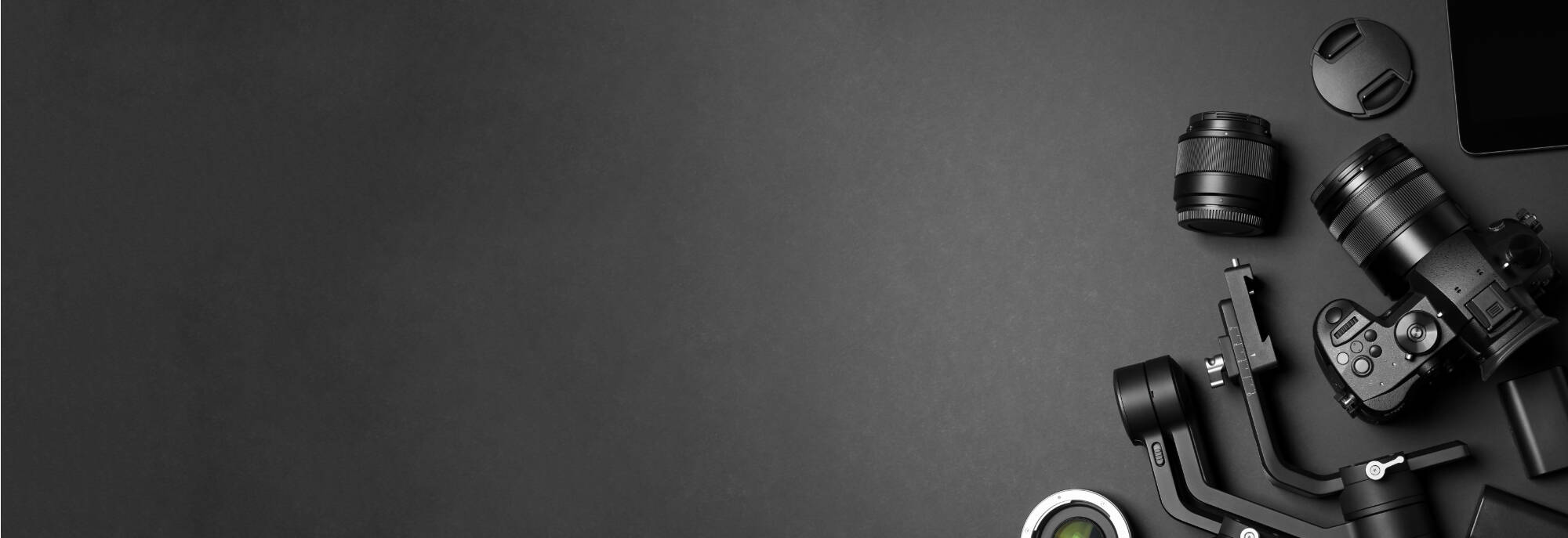 flat lay composition with camera and video production equipment on black background